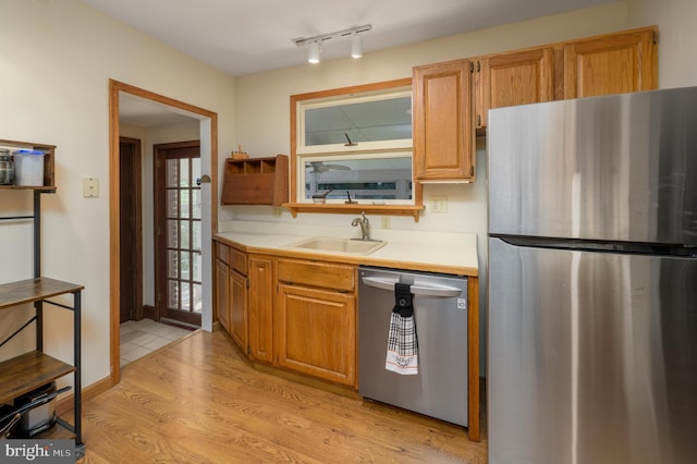 416 Copley Rd, Haddonfield, NJ 08033 - kitchen with stainless steel appliances, light countertops, light wood-style flooring, and brown cabinetry