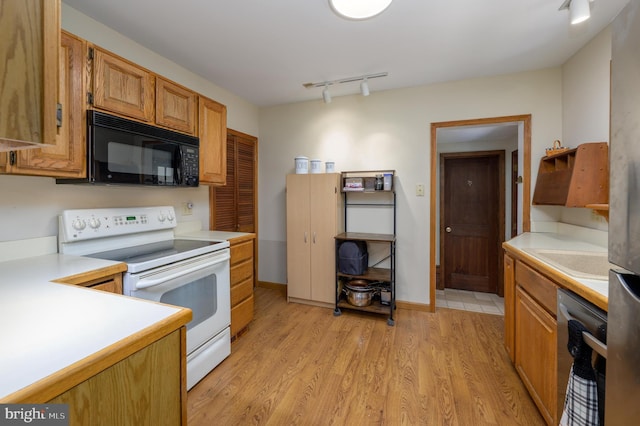 416 Copley Rd, Haddonfield, NJ 08033 - kitchen with electric range, black microwave, dishwashing machine, rail lighting, and light countertops