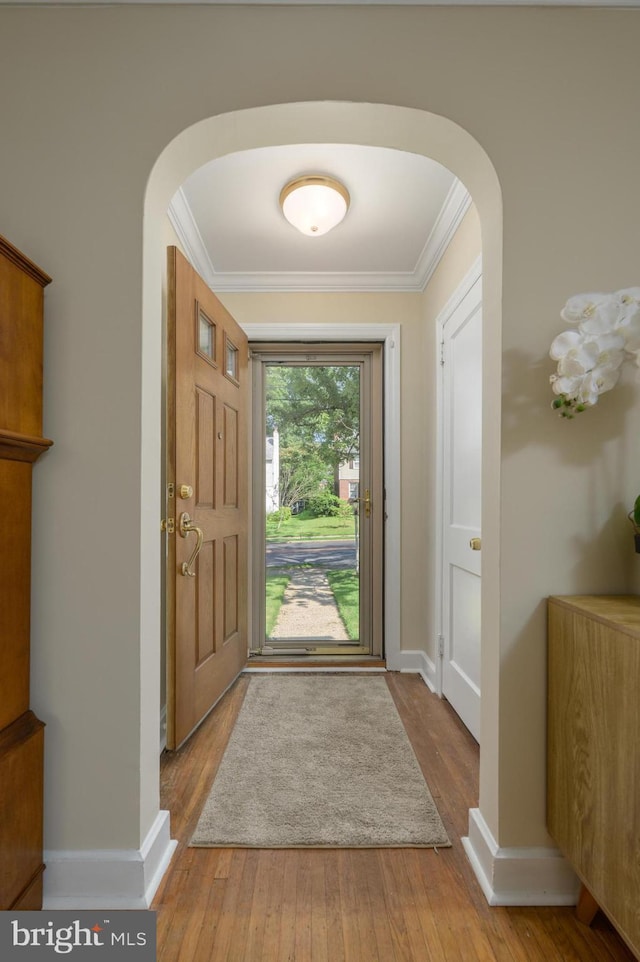 416 Copley Rd, Haddonfield, NJ 08033 - entrance foyer with arched walkways, ornamental molding, and hardwood / wood-style flooring