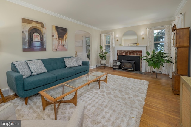416 Copley Rd, Haddonfield, NJ 08033 - living room featuring ornamental molding, wood finished floors, a wood stove, and arched walkways