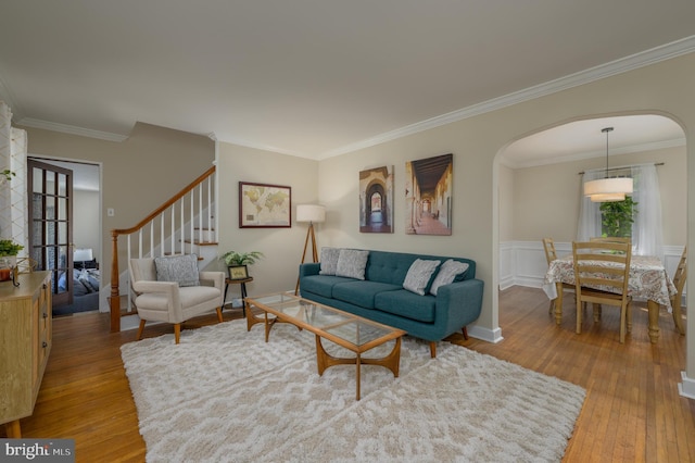 416 Copley Rd, Haddonfield, NJ 08033 - living room featuring arched walkways, hardwood / wood-style floors, ornamental molding, and stairway