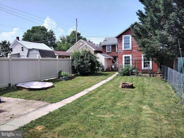 221 Princess St, Hanover, PA 17331 - fenced backyard featuring an outdoor fire pit and a storage unit