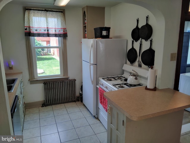 221 Princess St, Hanover, PA 17331 - kitchen with radiator heating unit, white gas range, dishwasher, light tile patterned flooring, and light countertops