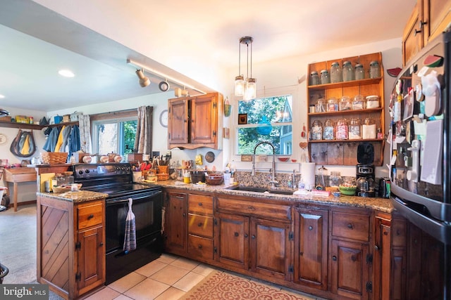 1119 Summit Ave, Front Royal, VA 22630 - kitchen featuring black appliances, a peninsula, light stone countertops, light tile patterned floors, and brown cabinetry