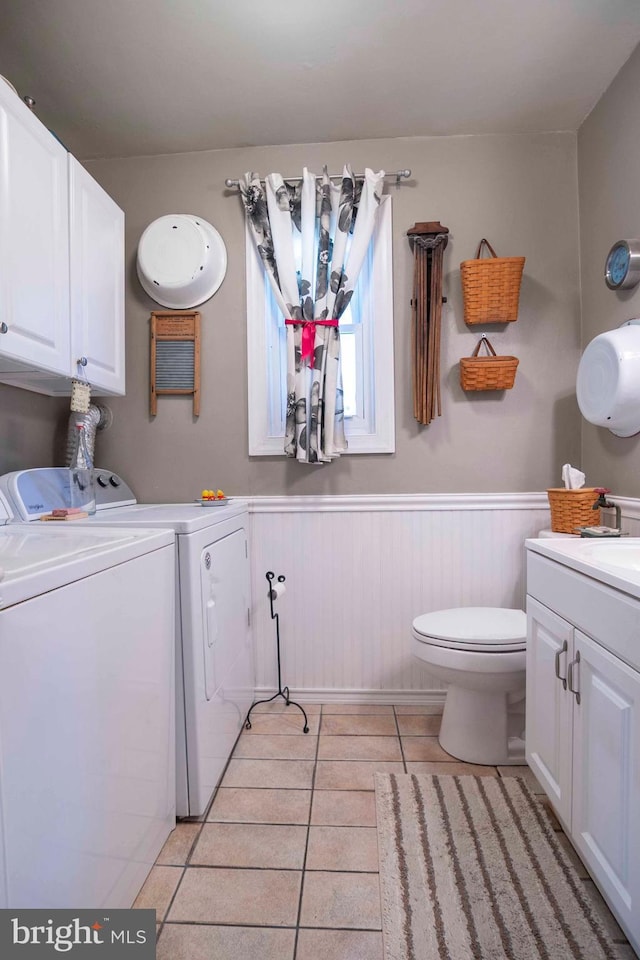 1119 Summit Ave, Front Royal, VA 22630 - bathroom with separate washer and dryer, tile patterned flooring, vanity, and wainscoting