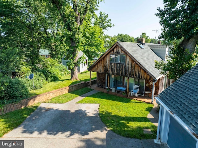 1119 Summit Ave, Front Royal, VA 22630 - back of property featuring a porch, a chimney, a yard, and a shingled roof