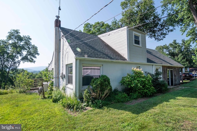 1119 Summit Ave, Front Royal, VA 22630 - view of home's exterior with roof with shingles, a chimney, a yard, and stucco siding