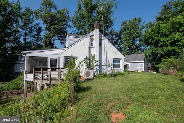 1119 Summit Ave, Front Royal, VA 22630 - view of home's exterior featuring a storage shed, a yard, a chimney, a wooden deck, and stucco siding