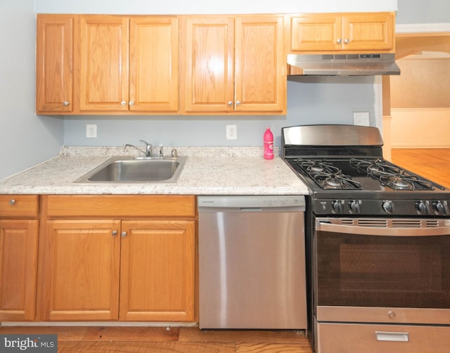 4917 Pembridge Ave, Baltimore, MD 21215 - kitchen with stainless steel appliances, under cabinet range hood, and light stone countertops