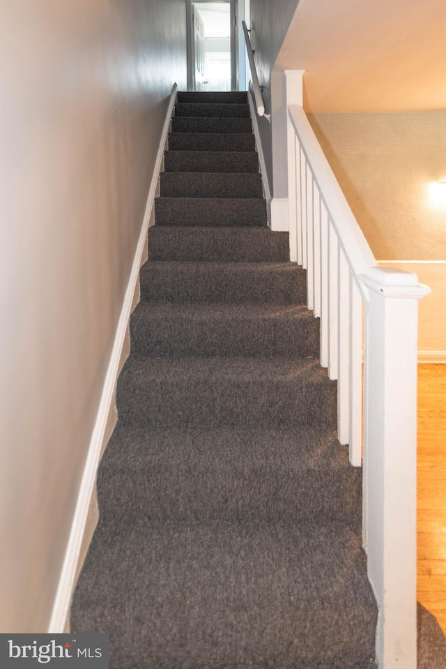 4917 Pembridge Ave, Baltimore, MD 21215 - stairs with baseboards and wood finished floors