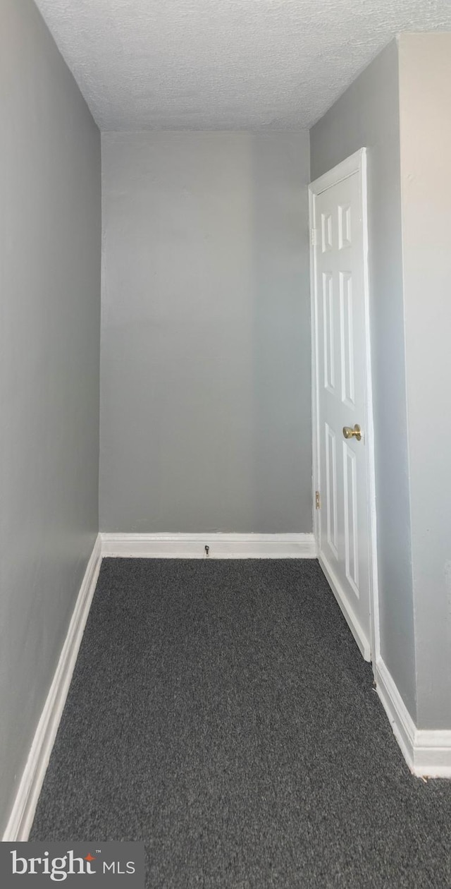 4917 Pembridge Ave, Baltimore, MD 21215 - empty room featuring carpet floors and a textured ceiling