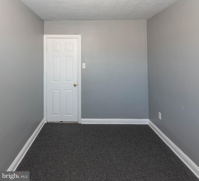 4917 Pembridge Ave, Baltimore, MD 21215 - empty room with dark carpet and a textured ceiling