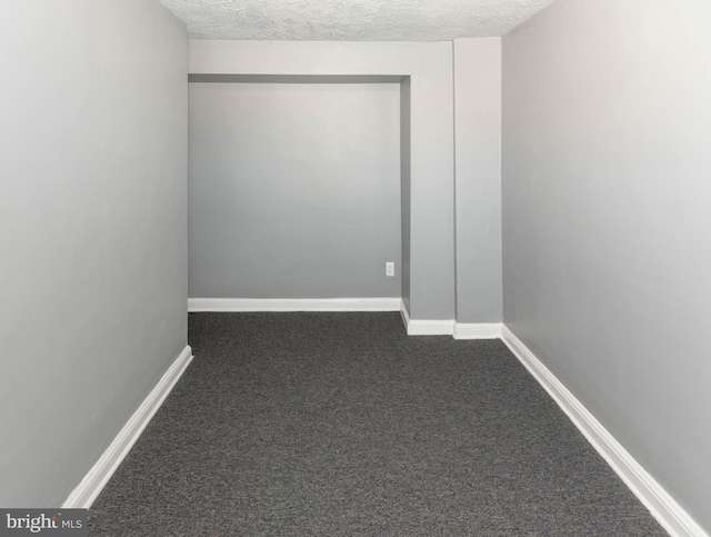 4917 Pembridge Ave, Baltimore, MD 21215 - empty room with dark colored carpet and a textured ceiling