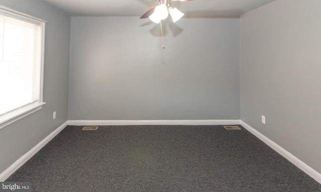 4917 Pembridge Ave, Baltimore, MD 21215 - unfurnished room with dark colored carpet, healthy amount of natural light, and a ceiling fan
