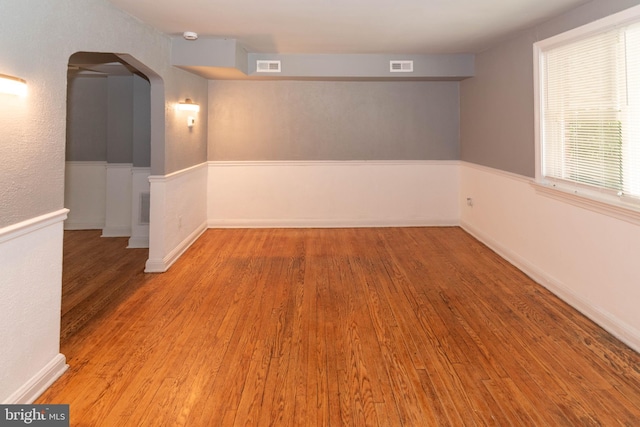 4917 Pembridge Ave, Baltimore, MD 21215 - spare room with wood finished floors, arched walkways, and a smoke detector