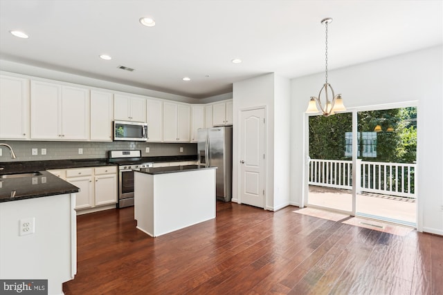 12814 Sutherby Ln, Germantown, MD 20874 - kitchen with appliances with stainless steel finishes, backsplash, dark wood finished floors, white cabinets, and recessed lighting