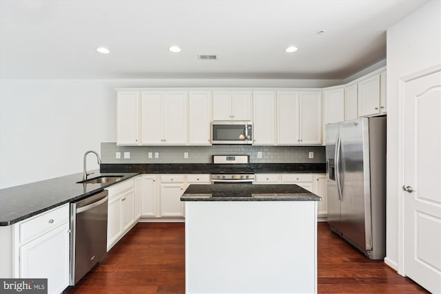 12814 Sutherby Ln, Germantown, MD 20874 - kitchen featuring stainless steel appliances, a peninsula, a center island, dark stone counters, and backsplash