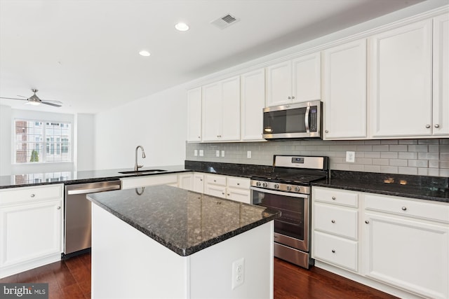 12814 Sutherby Ln, Germantown, MD 20874 - kitchen with stainless steel appliances, a peninsula, white cabinets, tasteful backsplash, and recessed lighting