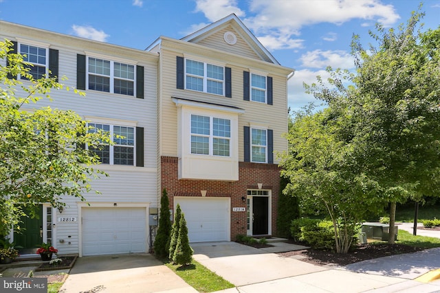12814 Sutherby Ln, Germantown, MD 20874 - multi unit property with an attached garage, driveway, and brick siding