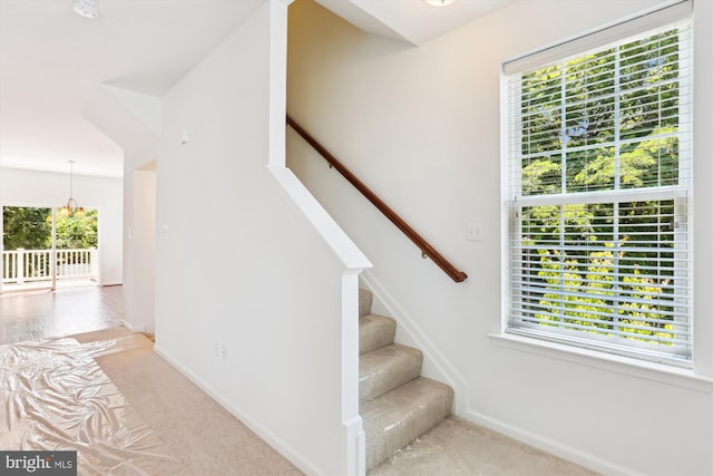 12814 Sutherby Ln, Germantown, MD 20874 - stairway featuring healthy amount of natural light, carpet floors, and a chandelier
