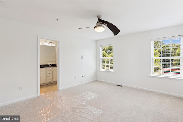12814 Sutherby Ln, Germantown, MD 20874 - unfurnished bedroom with light colored carpet, ensuite bath, and a ceiling fan
