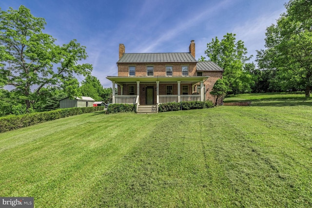 7901 Warfield Rd, Gaithersburg, MD 20882 - view of front of house featuring a standing seam roof, a chimney, covered porch, a front yard, and a metal roof