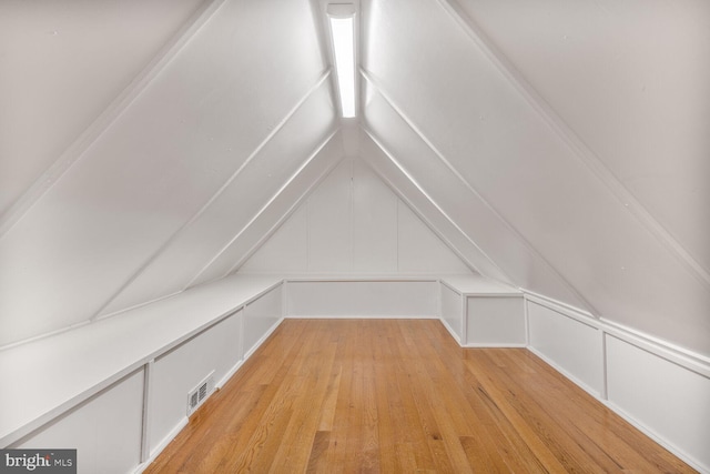 7901 Warfield Rd, Gaithersburg, MD 20882 - bonus room featuring light wood-style floors, a decorative wall, and vaulted ceiling