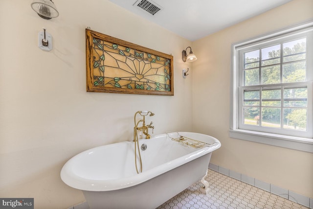 7901 Warfield Rd, Gaithersburg, MD 20882 - full bathroom featuring a freestanding bath and baseboards