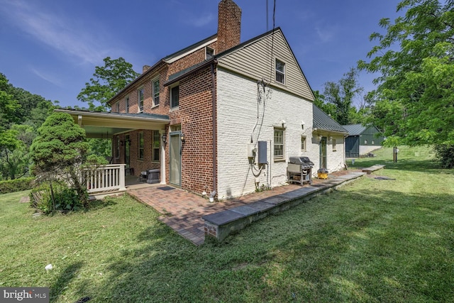 7901 Warfield Rd, Gaithersburg, MD 20882 - view of side of home featuring a chimney, a lawn, brick siding, and a patio area