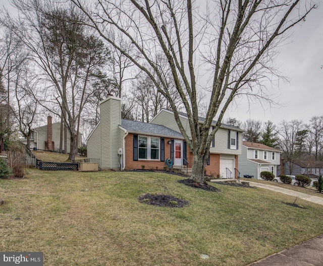 9907 Treetop Ln, Lanham, MD 20706 - tri-level home with brick siding, driveway, an attached garage, a chimney, and a front lawn