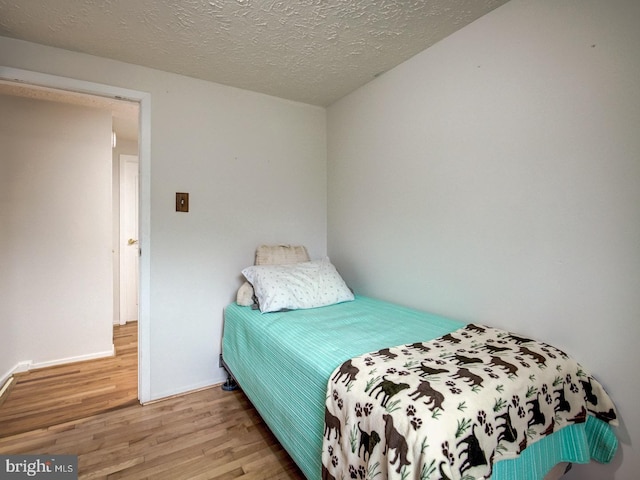 9907 Treetop Ln, Lanham, MD 20706 - bedroom with wood finished floors and a textured ceiling