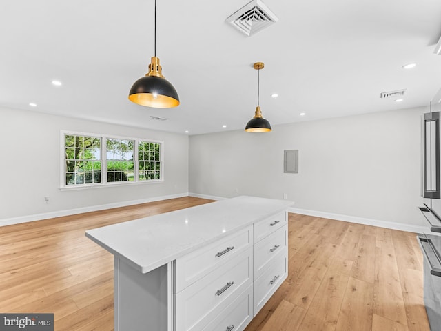 357 Avis Mill Rd, Pilesgrove, NJ 08098 - kitchen with light countertops, light wood finished floors, white cabinets, decorative light fixtures, and recessed lighting