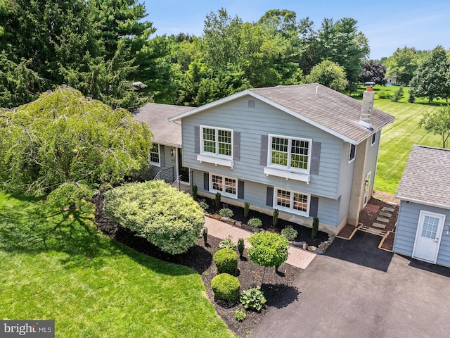 357 Avis Mill Rd, Pilesgrove, NJ 08098 - split level home featuring stairs, a shingled roof, a chimney, and a front lawn