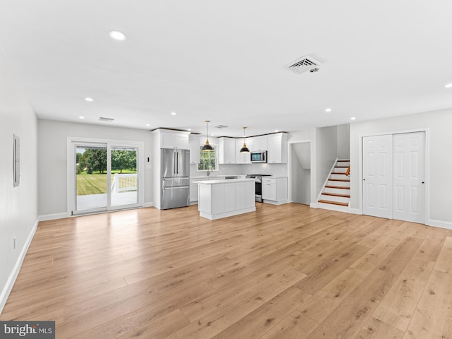 357 Avis Mill Rd, Pilesgrove, NJ 08098 - unfurnished living room with recessed lighting, light wood-type flooring, and stairs