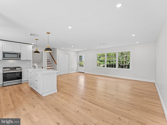 357 Avis Mill Rd, Pilesgrove, NJ 08098 - kitchen featuring stainless steel appliances, recessed lighting, white cabinets, light wood finished floors, and light countertops
