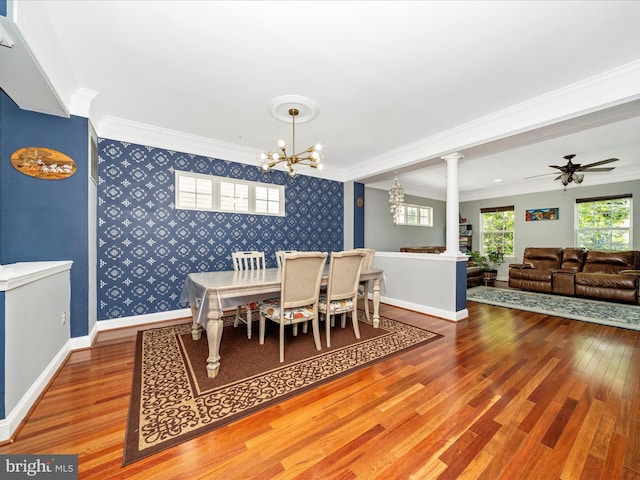 12404 Carriage Park Pl, Clarksburg, MD 20871 - dining area featuring wallpapered walls, decorative columns, wood finished floors, an accent wall, and crown molding