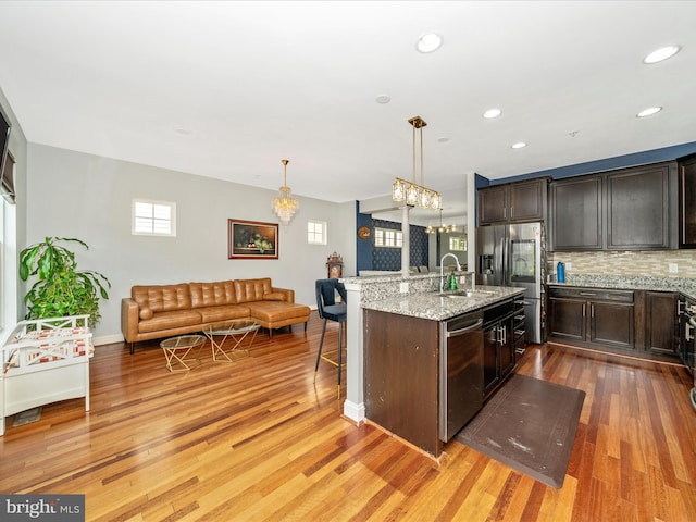12404 Carriage Park Pl, Clarksburg, MD 20871 - kitchen with appliances with stainless steel finishes, a chandelier, plenty of natural light, light wood-style floors, and recessed lighting