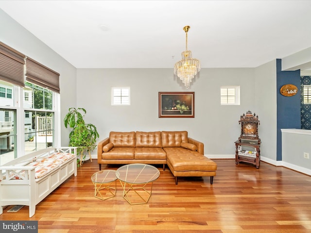 12404 Carriage Park Pl, Clarksburg, MD 20871 - living room featuring light wood-style flooring, plenty of natural light, and a chandelier