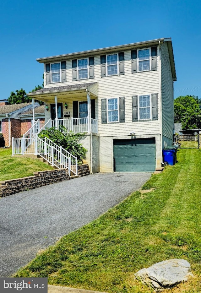 1055 View St, Hagerstown, MD 21742 - view of front facade with asphalt driveway, an attached garage, a front lawn, and a porch