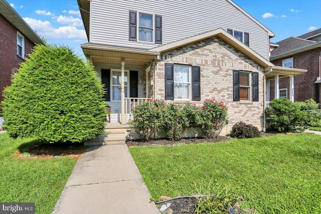 311 Woodside, West Lawn, PA 19609 - view of front of house featuring covered porch, a front yard, and brick siding