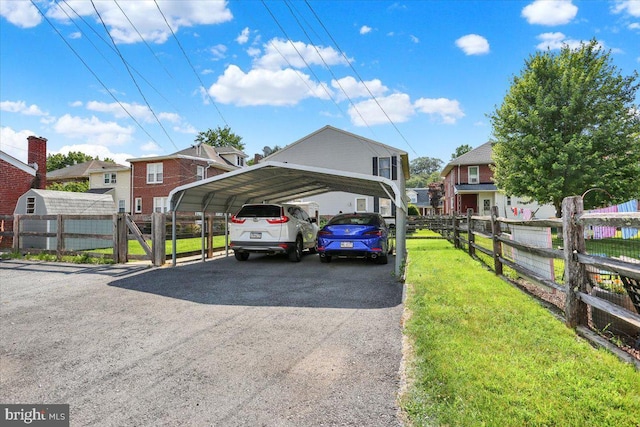311 Woodside, West Lawn, PA 19609 - view of vehicle parking featuring a detached carport, a residential view, and asphalt driveway