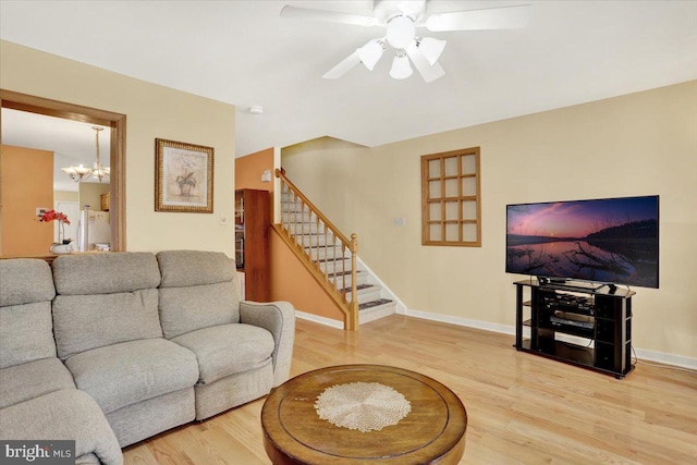 311 Woodside, West Lawn, PA 19609 - living room with stairs, wood finished floors, a chandelier, and a ceiling fan