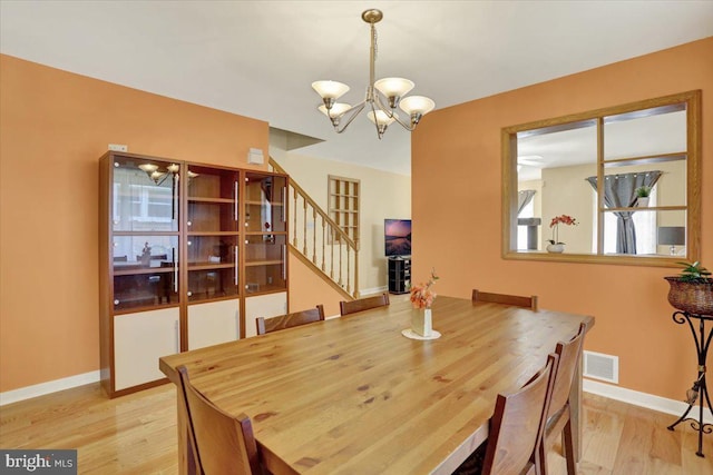 311 Woodside, West Lawn, PA 19609 - dining area featuring a chandelier, stairway, and wood finished floors