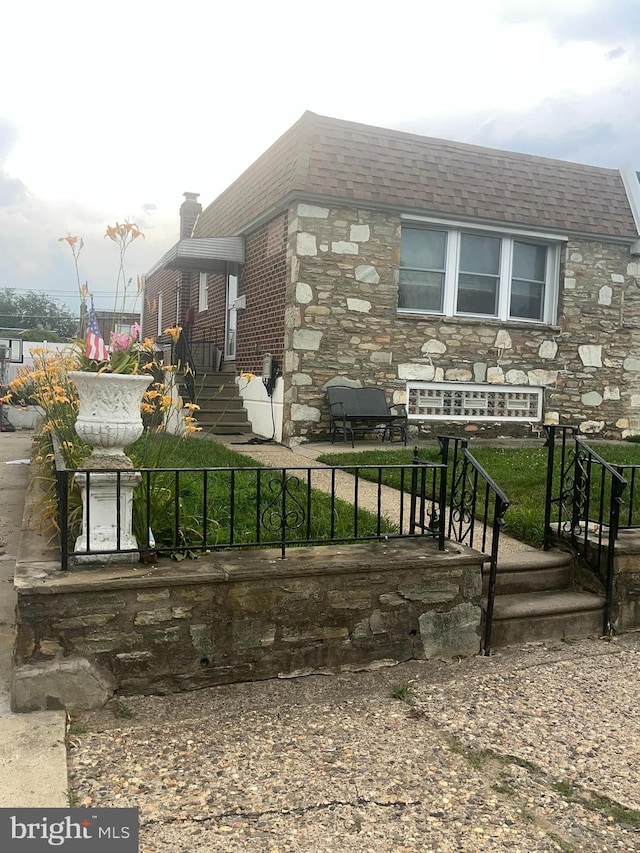 2018 Greymont St, Philadelphia, PA 19116 - view of front of home with stone siding and a chimney
