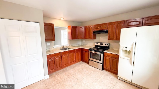 1000 Old Forge Rd, New Castle, DE 19720 - kitchen with white refrigerator with ice dispenser, stainless steel range with electric stovetop, under cabinet range hood, brown cabinets, and light tile patterned flooring