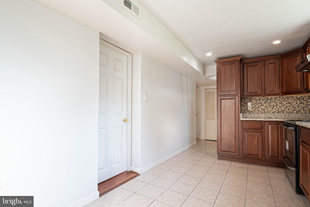 1262 Everett Ave, Woodbridge, VA 22191 - kitchen with black range with electric stovetop, tasteful backsplash, recessed lighting, light tile patterned floors, and light stone counters