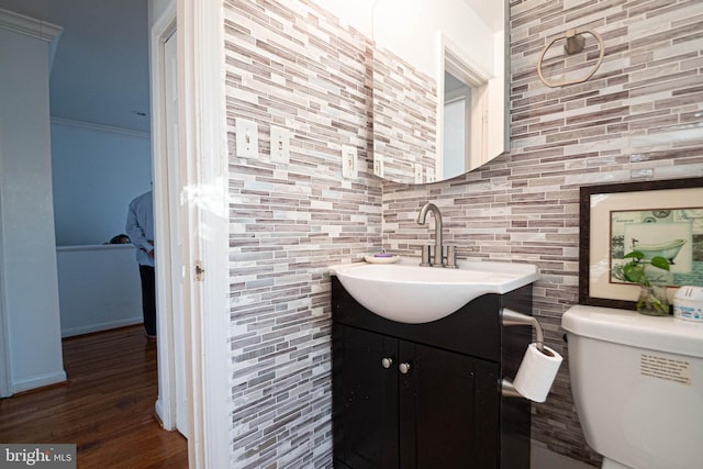 1262 Everett Ave, Woodbridge, VA 22191 - half bathroom featuring vanity, decorative backsplash, and wood finished floors