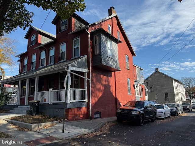 47 S Marshall St, Lancaster, PA 17602 - view of home's exterior featuring a chimney, a porch, and brick siding