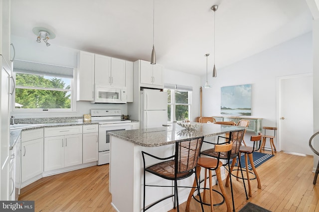 365 Dusty Miller Dr, Long Beach, NJ 08008 - kitchen with white appliances, light wood-type flooring, lofted ceiling, light stone countertops, and a kitchen breakfast bar