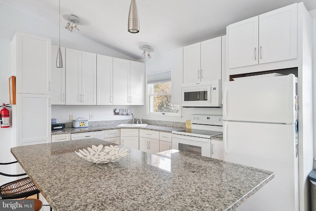 365 Dusty Miller Dr, Long Beach, NJ 08008 - kitchen with white appliances, vaulted ceiling, white cabinetry, a kitchen breakfast bar, and light stone counters